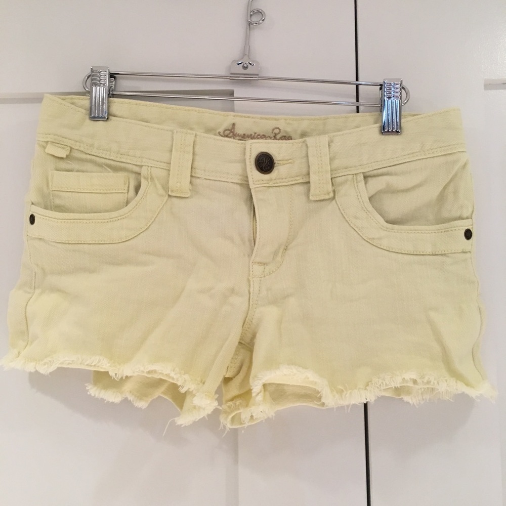 Pastel yellow denim cutoff shorts